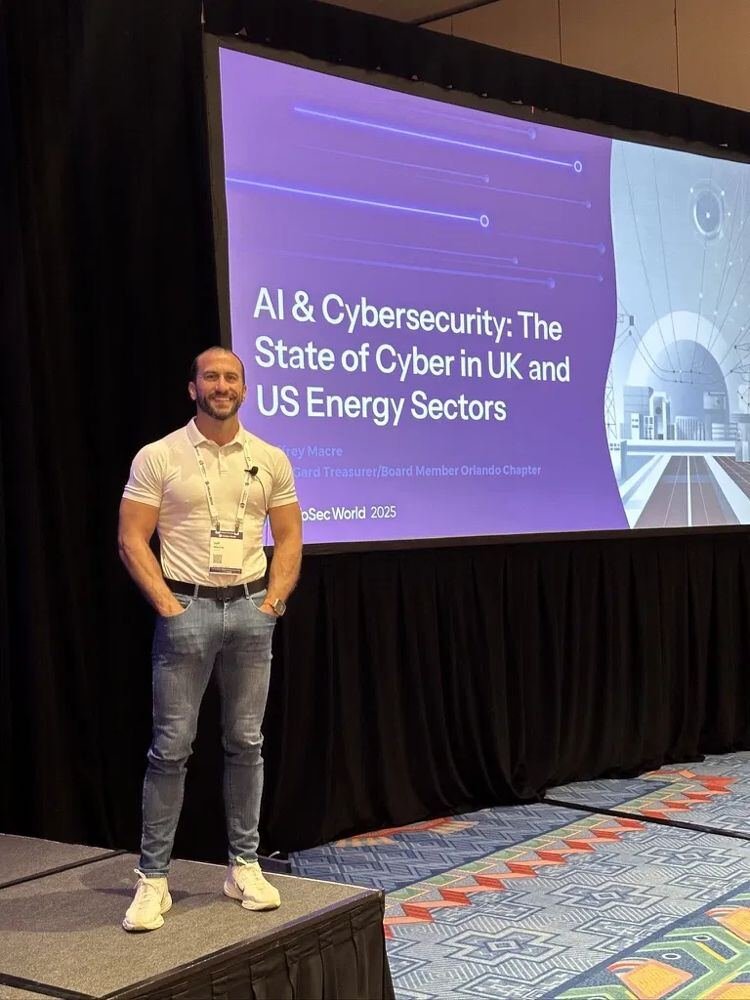 Jeffrey Macre beside his AI and Cybersecurity title slide at InfoSec World